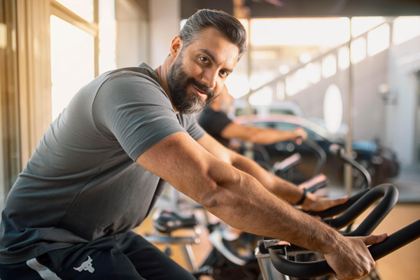 Man riding a fitness bike in gym