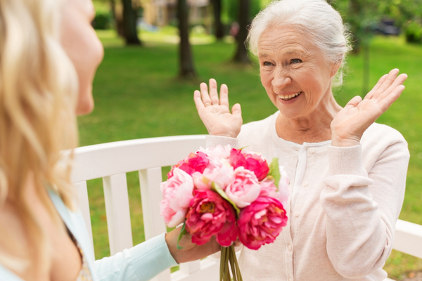daughter giving mom flowers