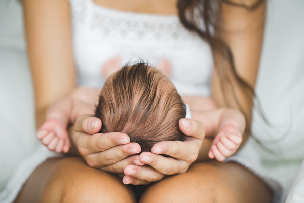A mom holding a newborn in her lap