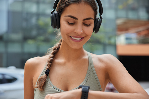 Person wearing high-tech, trendy workout equipment including smart watch and wireless headphones