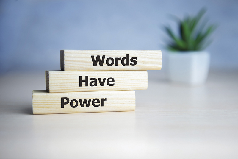 Wooden blocks on table reading "Words Have Power"