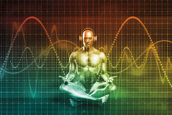 Graphic of person sitting down cross legged in meditative pose with headphones on surrounded by sound waves